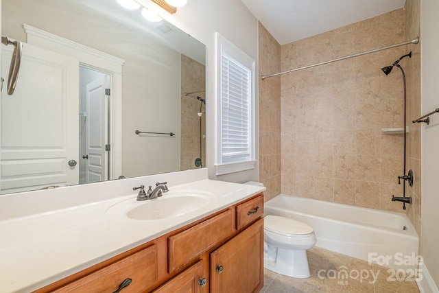 full bathroom featuring tiled shower / bath, vanity, and toilet