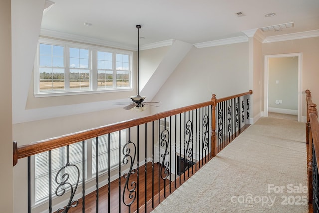 corridor with ornamental molding and hardwood / wood-style floors