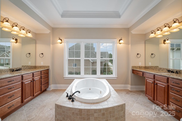 bathroom with ornamental molding, tiled bath, and a raised ceiling