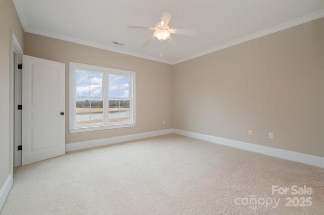 carpeted empty room featuring ornamental molding and ceiling fan