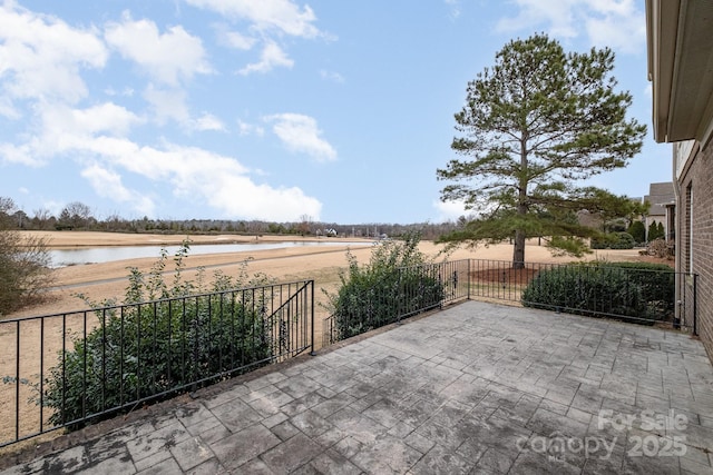 view of patio featuring a water view