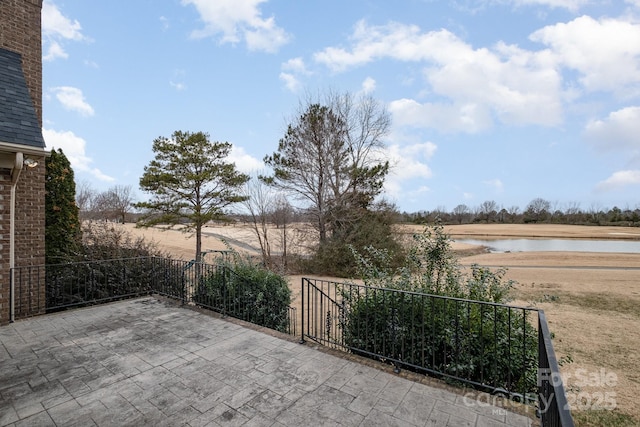 view of patio with a water view