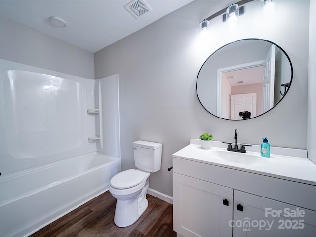 full bathroom with toilet, hardwood / wood-style flooring, tub / shower combination, and vanity