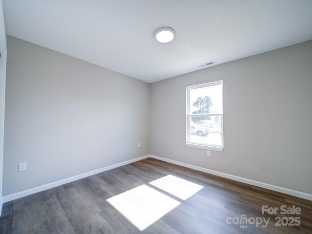 empty room with wood-type flooring