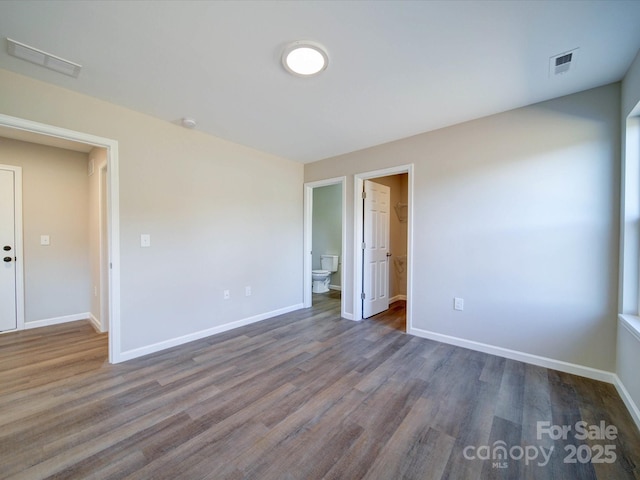 spare room featuring dark hardwood / wood-style floors