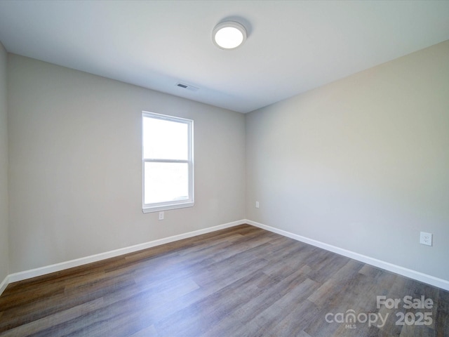 spare room featuring hardwood / wood-style flooring