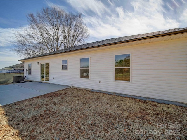 back of property featuring central air condition unit and a patio