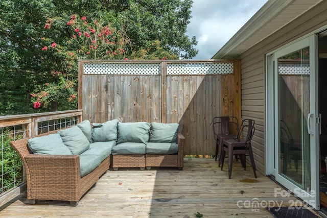 wooden terrace featuring an outdoor living space