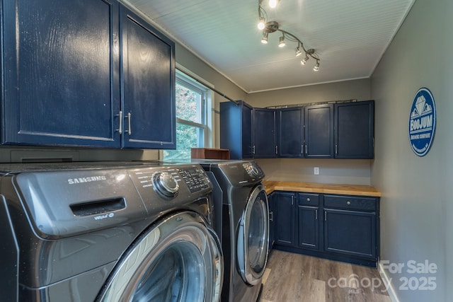 washroom with cabinets, track lighting, washer and dryer, and light wood-type flooring