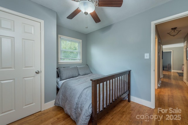 bedroom with ceiling fan and hardwood / wood-style floors