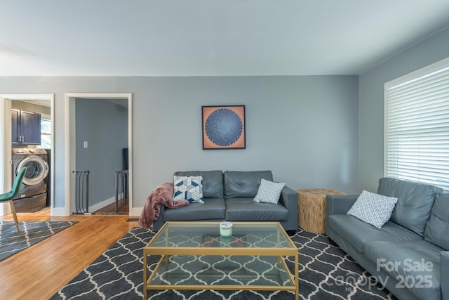 living room with washer / clothes dryer and hardwood / wood-style floors