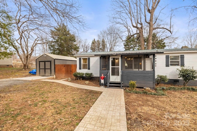 view of front of house featuring a front yard and a shed