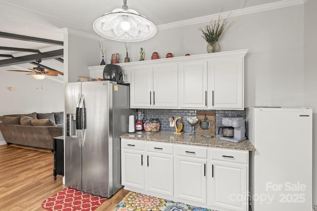 kitchen with white cabinetry, white fridge, decorative light fixtures, and stainless steel fridge with ice dispenser