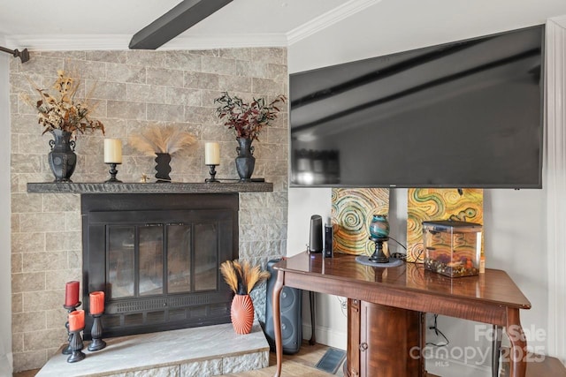 interior details featuring crown molding and a tile fireplace