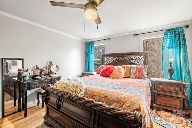 bedroom featuring crown molding, ceiling fan, and light hardwood / wood-style floors