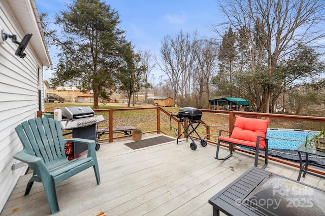 wooden deck featuring a grill