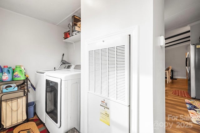 laundry area featuring hardwood / wood-style flooring and independent washer and dryer