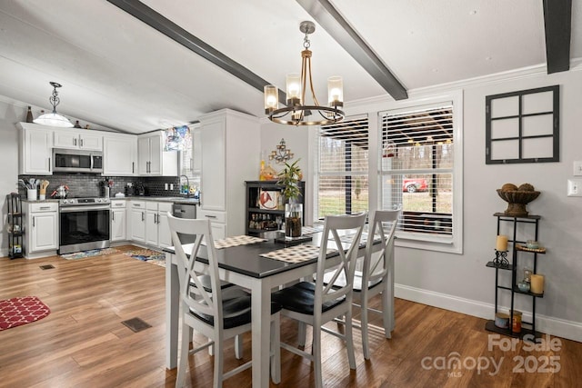 dining area featuring lofted ceiling with beams, hardwood / wood-style floors, and a wealth of natural light