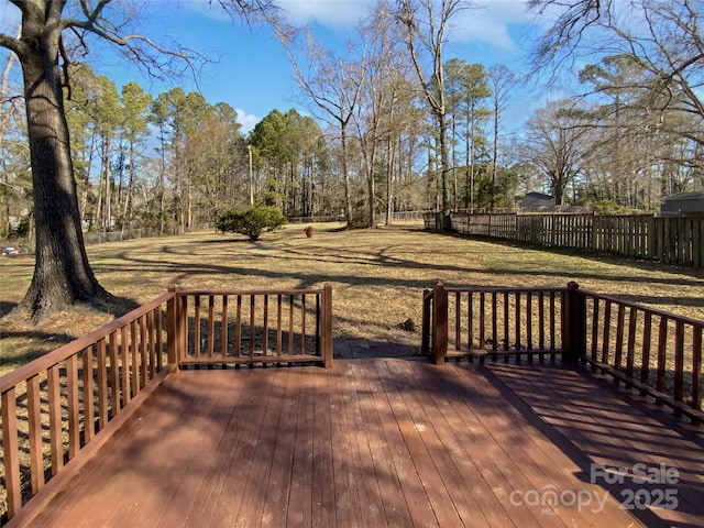 wooden terrace featuring a yard