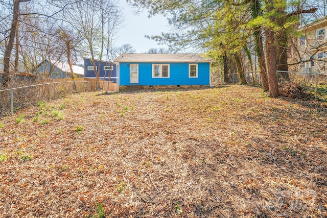 rear view of house with crawl space and a fenced backyard