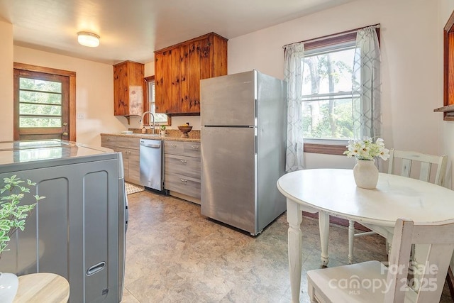 28 Robindale Ave, Asheville, NC 28801 - kitchen featuring stainless steel appliances, plenty of natural light, brown cabinetry, and light countertops