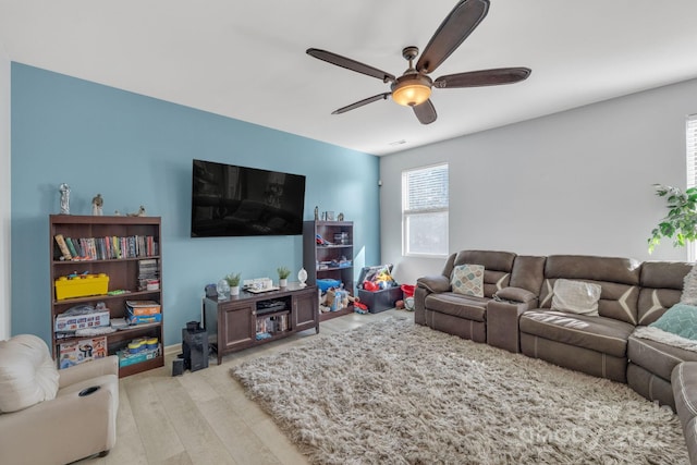 living room with ceiling fan and light wood-type flooring