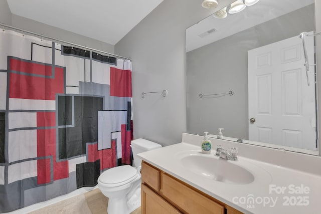 bathroom with vanity, walk in shower, and toilet