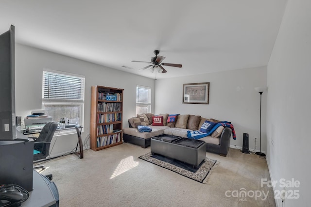 carpeted living room with ceiling fan