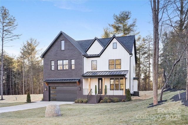 modern inspired farmhouse with a front yard, a standing seam roof, a porch, concrete driveway, and metal roof