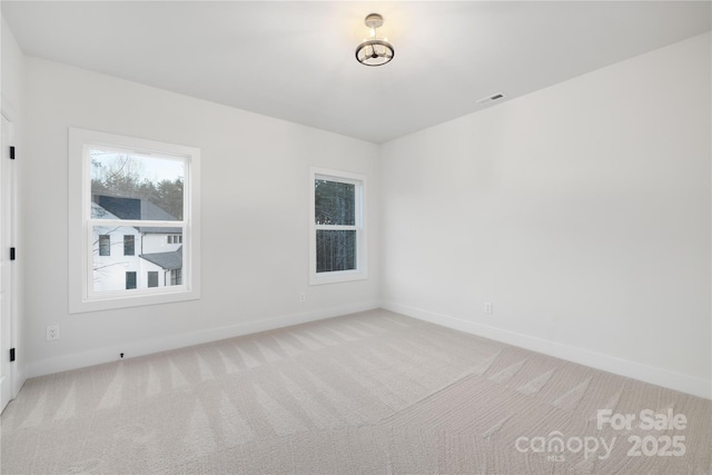 empty room featuring light carpet