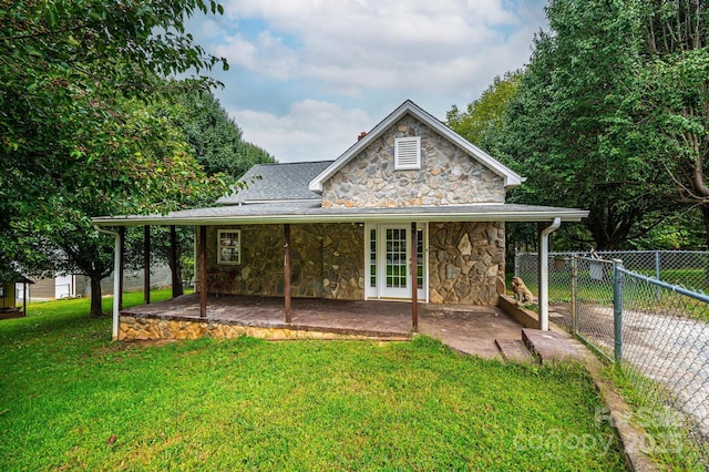 rear view of house with a yard and a patio