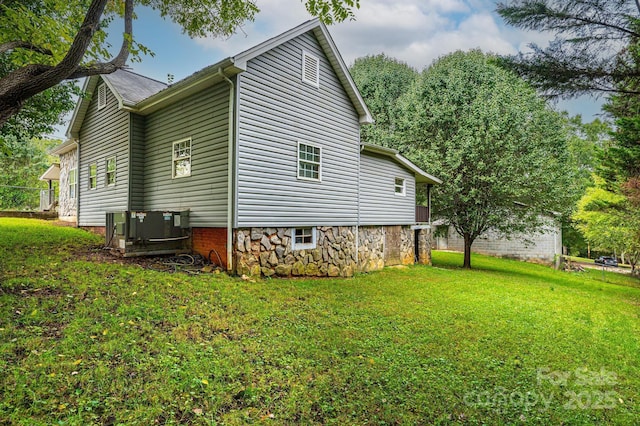 view of property exterior featuring cooling unit and a yard