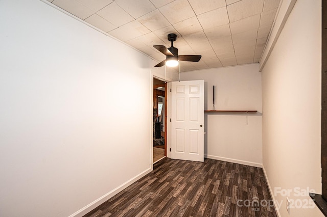 spare room with ceiling fan and dark wood-type flooring