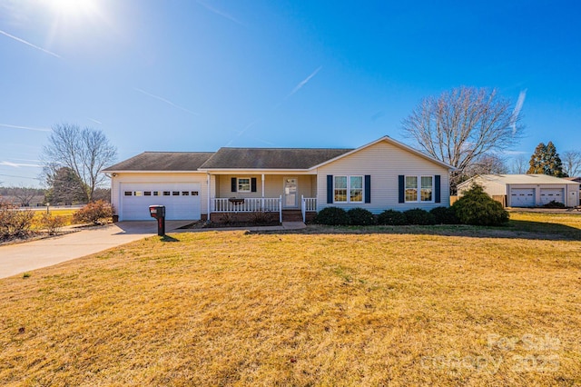 ranch-style house featuring a garage, a front yard, and covered porch