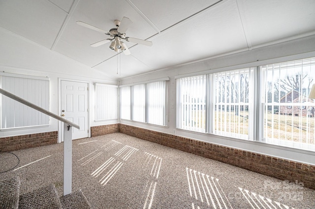 unfurnished sunroom with vaulted ceiling and ceiling fan