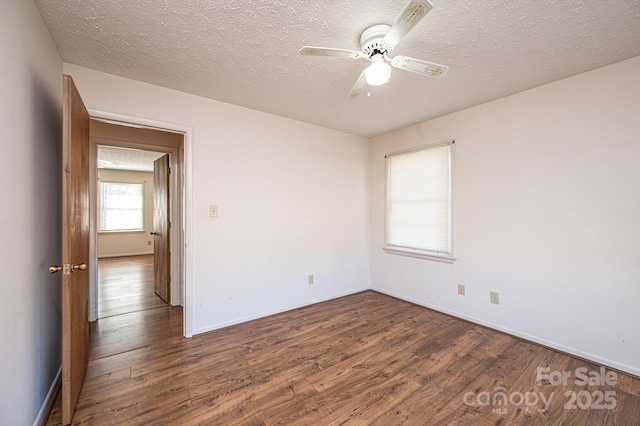 spare room with hardwood / wood-style flooring, a textured ceiling, and ceiling fan