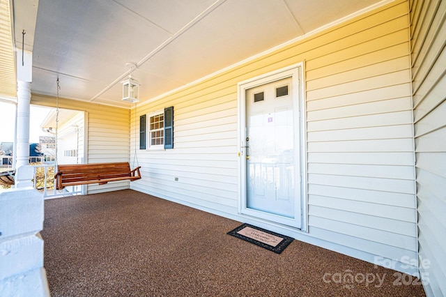 doorway to property featuring a porch