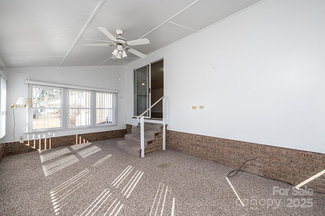 miscellaneous room featuring ceiling fan, carpet flooring, and vaulted ceiling