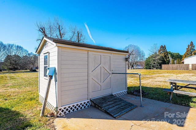 view of outbuilding featuring a yard