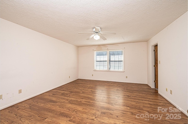 spare room featuring ceiling fan, a textured ceiling, and dark hardwood / wood-style flooring