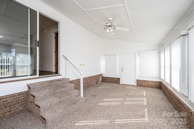 unfurnished sunroom featuring vaulted ceiling and ceiling fan