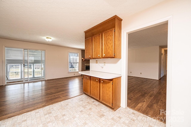 kitchen featuring light hardwood / wood-style floors and a textured ceiling