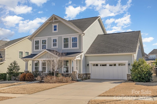 craftsman-style house featuring driveway, stone siding, roof with shingles, and an attached garage