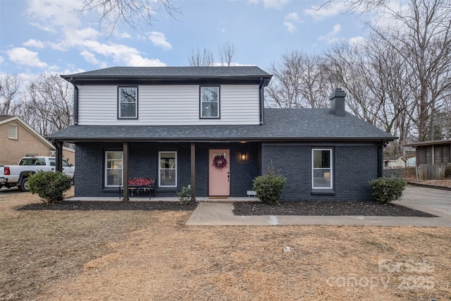 view of front property featuring a porch and a front yard