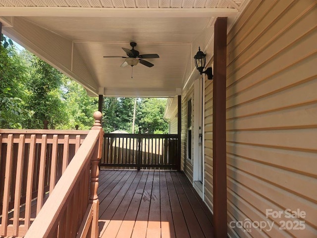 wooden deck featuring ceiling fan