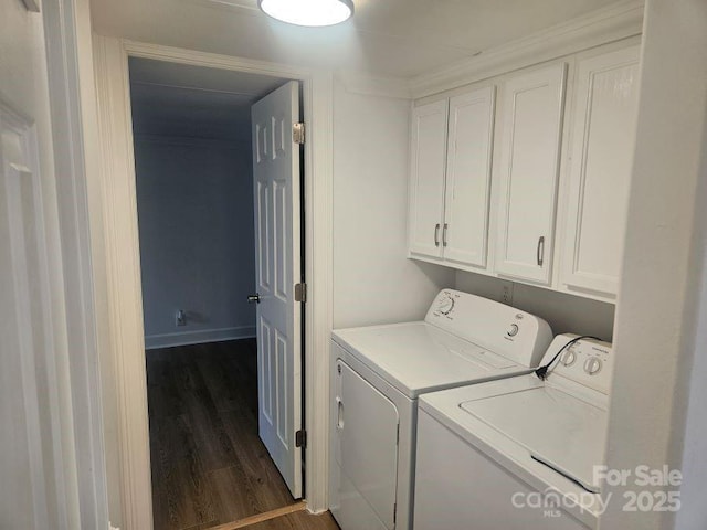 laundry room with cabinets, washer and clothes dryer, and dark hardwood / wood-style flooring