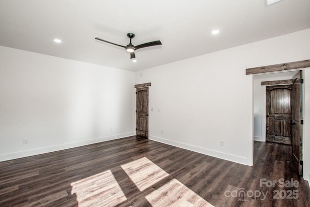 spare room featuring ceiling fan and dark wood-type flooring