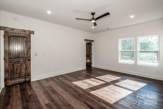 spare room with ceiling fan and dark hardwood / wood-style floors