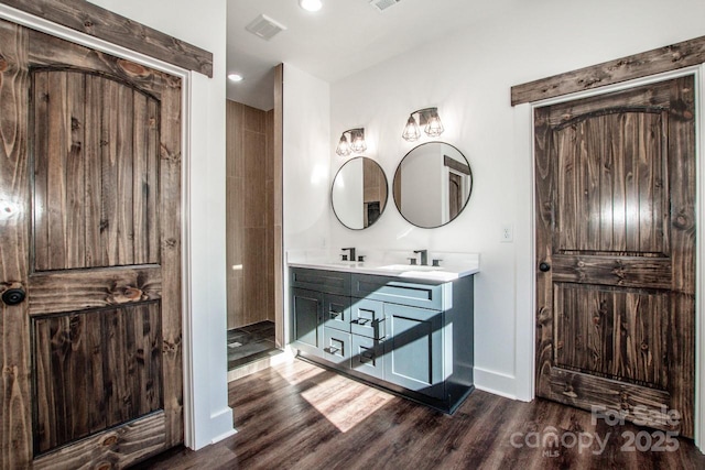 bathroom with hardwood / wood-style flooring and vanity