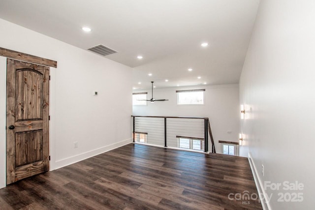 unfurnished room with ceiling fan and dark hardwood / wood-style flooring